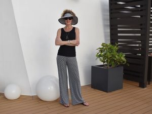 Woman in palazzo pants and black tank
