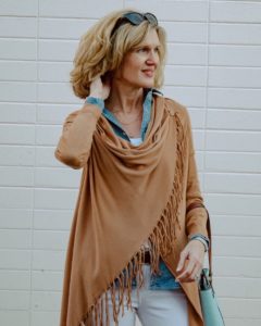 Woman in tan shawl with denim shirt