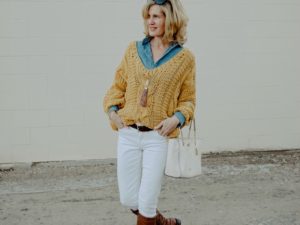 Woman in yellow sweater and white pants