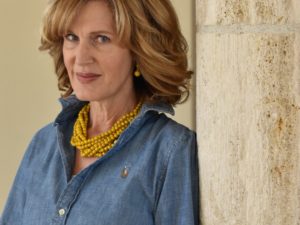 woman wearing denim shirt with yellow necklace