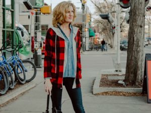 Woman in outfit with red plaid jacket