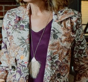 Upclose photo of purple blouse and floral jacket
