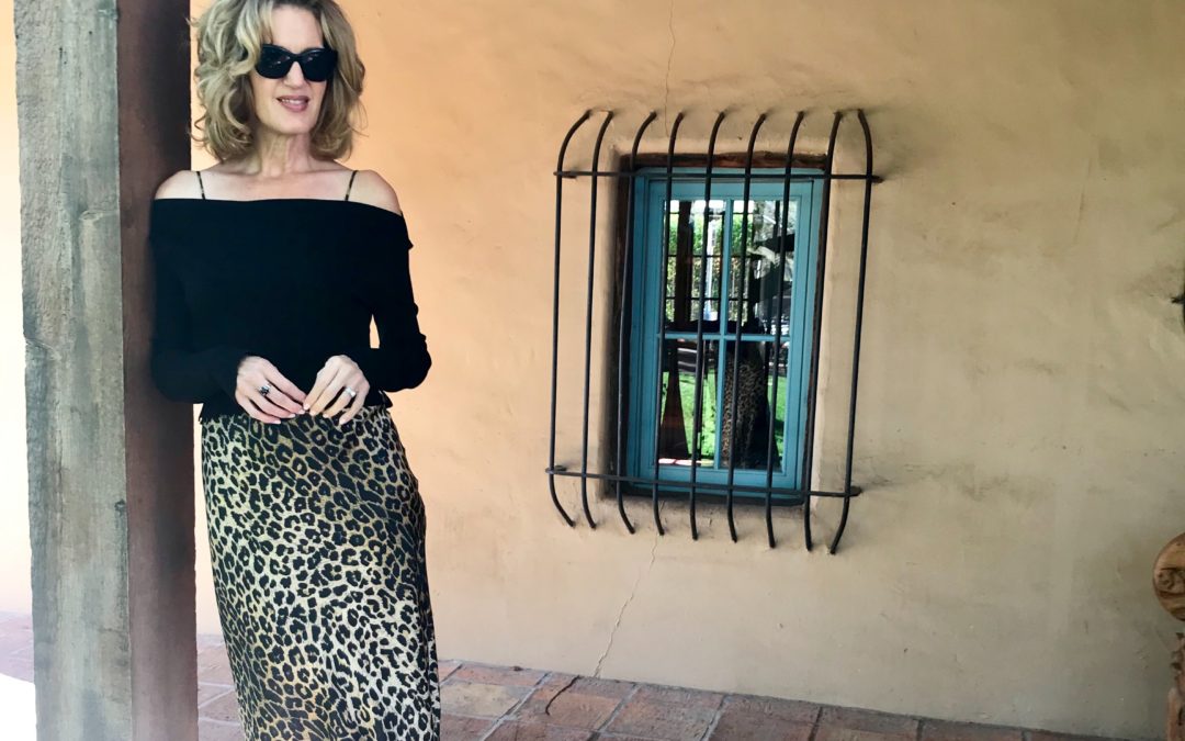 Woman wearing leopard skirt and black sweater