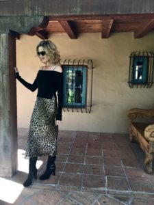 woman wearing leopard print skirt and black sweater