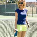 Woman in blue and yellow tennis outfit