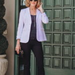 Woman wearing white blazer over black outfit