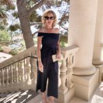 Lisa from MidlifeinBloom.com shows an off-the-shoulder, navy blue jumpsuit