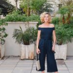Lisa from Midlifeinbloom shows an off-the-shoulder, navy jumpsuit