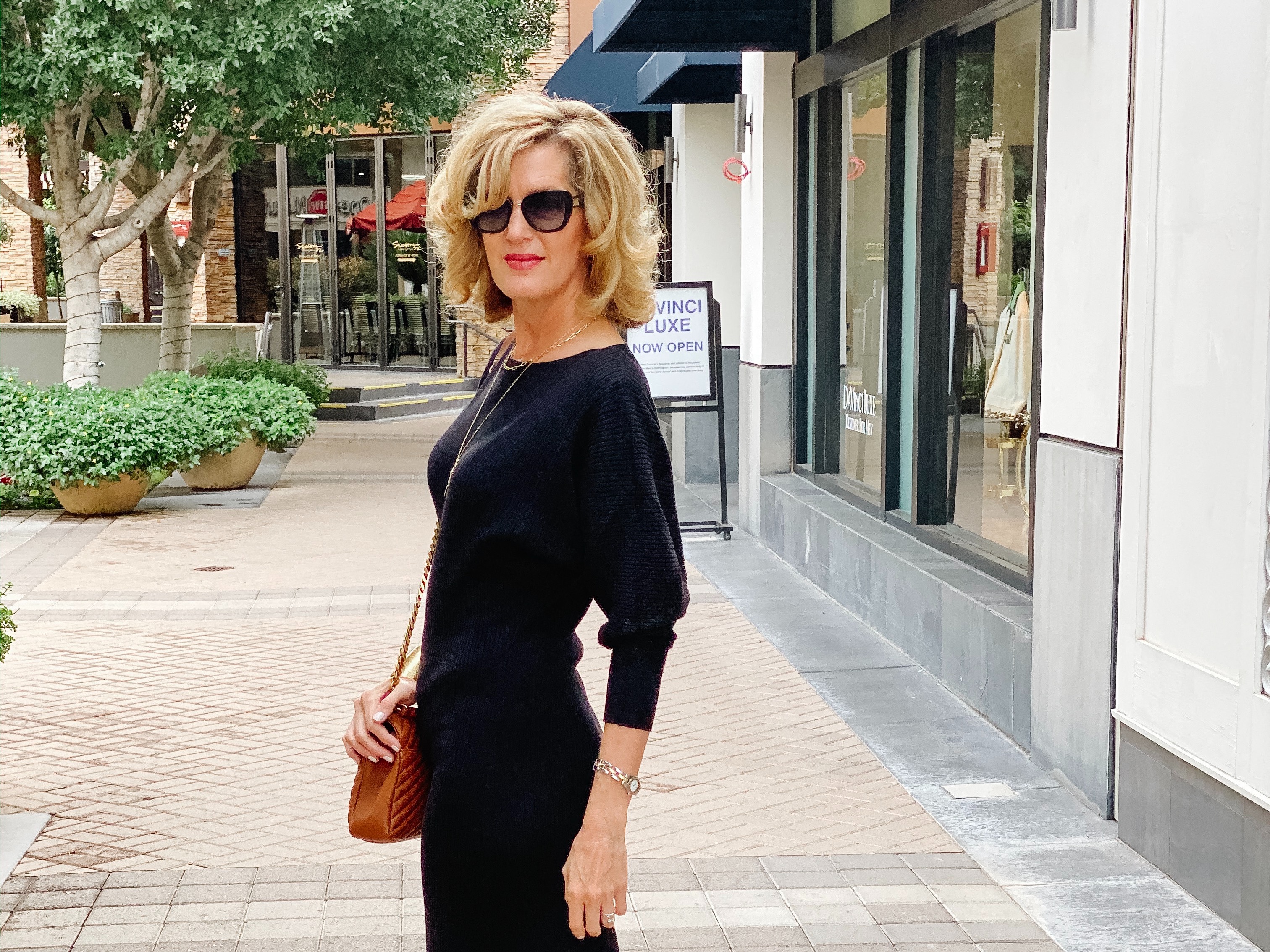 Lisa from Midlifeinbloom.com shows a flattering midi-length sweater dress
