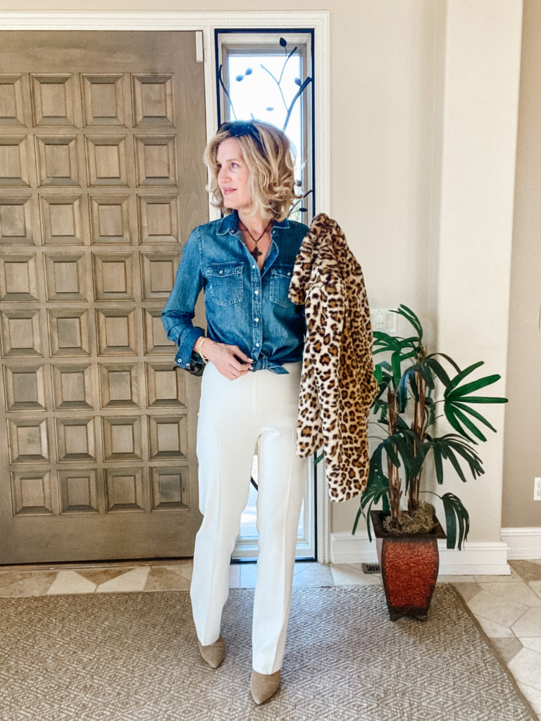 white pants styled with denim shirt and leopard jacket