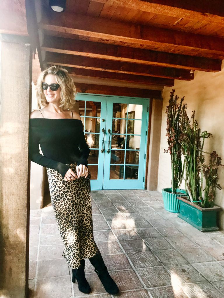 Lisa from Midlifeinbloom.com showing a leopard-print slip dress