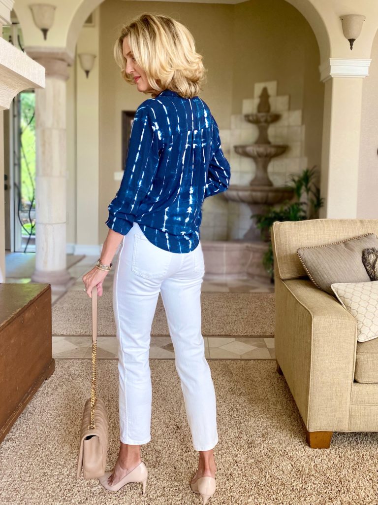 Lisa from Midlifeinbloom.com shows blue and white blouse with white jeans and neutral accessories